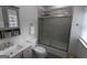 Bathroom features a gray vanity, a frosted glass enclosed shower, and natural light at 997 Boulevard Se, Atlanta, GA 30312