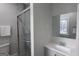 Neutral bathroom featuring shower with sliding glass door, gray vanity, and mirror at 997 Boulevard Se, Atlanta, GA 30312