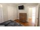 Bedroom with hardwood floors, dresser, closet, and doorway leading to another room at 997 Boulevard Se, Atlanta, GA 30312