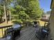 Wooden deck with outdoor seating and barbecue overlooking the backyard at 2889 Carrousel Ct, Stone Mountain, GA 30087