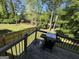 Wooden deck with barbecue and backyard view at 2889 Carrousel Ct, Stone Mountain, GA 30087