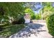 Long driveway leading to a two-car garage surrounded by lush greenery, offering ample parking space at 2889 Carrousel Ct, Stone Mountain, GA 30087