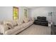 Spacious living room featuring a large sofa and hardwood floors at 2889 Carrousel Ct, Stone Mountain, GA 30087