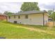The home's exterior has a brick facade and there is a large grassy backyard at 7279 Mayfair Cir, Jonesboro, GA 30236