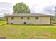 The home's backyard has an AC unit and fresh, green grass at 7279 Mayfair Cir, Jonesboro, GA 30236