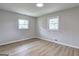 Bright bedroom featuring wood floors, two windows, and neutral paint at 7279 Mayfair Cir, Jonesboro, GA 30236
