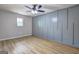 Bedroom features ceiling fan, sleek floors, and a spacious closet at 7279 Mayfair Cir, Jonesboro, GA 30236