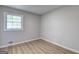 Bright bedroom featuring wood floors, window, and neutral paint at 7279 Mayfair Cir, Jonesboro, GA 30236