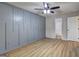 Bedroom features ceiling fan, sleek floors, and an en suite bathroom at 7279 Mayfair Cir, Jonesboro, GA 30236