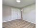 Bedroom with wood floors, closet and view into hallway at 7279 Mayfair Cir, Jonesboro, GA 30236