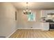 Charming dining area connected to the kitchen with natural light and modern chandelier at 7279 Mayfair Cir, Jonesboro, GA 30236