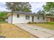 One-story home with brick details, a long driveway, and landscaping at 7279 Mayfair Cir, Jonesboro, GA 30236