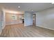A modern living room leads into a kitchen with white cabinets at 7279 Mayfair Cir, Jonesboro, GA 30236