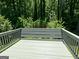 Wooden deck with gray paint overlooking a backyard full of trees at 2691 Old South Dr, Jonesboro, GA 30236