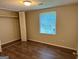 Bedroom featuring wood-look flooring, window with blinds, and closet space at 2691 Old South Dr, Jonesboro, GA 30236