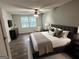 Cozy primary bedroom with a comfortable bed, a ceiling fan, and bedside lamps at 2691 Old South Dr, Jonesboro, GA 30236
