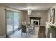 Bright dining room featuring a modern light fixture, fireplace, and a glass table with chairs at 2691 Old South Dr, Jonesboro, GA 30236