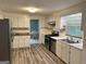 Bright kitchen with stainless steel appliances, white cabinetry, and wood-look flooring at 2691 Old South Dr, Jonesboro, GA 30236