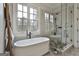 Elegant bathroom featuring a soaking tub, separate glass shower, and modern fixtures at 400 Conservatory Pt, Fayetteville, GA 30215