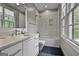 Stylish bathroom featuring quartz countertop vanity and modern shower with glass door at 400 Conservatory Pt, Fayetteville, GA 30215