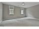 Bright bedroom with two windows, plush carpeting, and neutral walls at 400 Conservatory Pt, Fayetteville, GA 30215