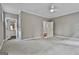 Spacious bedroom featuring neutral walls, plush carpet, and a ceiling fan for added comfort at 400 Conservatory Pt, Fayetteville, GA 30215