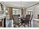Elegant dining room featuring a round table, chandelier, and large windows for ample natural light at 400 Conservatory Pt, Fayetteville, GA 30215