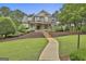 Elegant home with a stone facade, manicured landscaping, and a welcoming front porch at 400 Conservatory Pt, Fayetteville, GA 30215