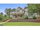 Charming two-story home with stone accents, a welcoming front porch, and beautifully landscaped front yard at 400 Conservatory Pt, Fayetteville, GA 30215