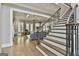 Grand foyer showcasing staircase with iron railings and an open view into the living spaces at 400 Conservatory Pt, Fayetteville, GA 30215