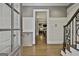 Inviting foyer with hardwood floors, white wainscoting, and an open view to the living area at 400 Conservatory Pt, Fayetteville, GA 30215