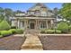 Inviting front porch with stone pathway leading to a beautiful home with manicured landscaping at 400 Conservatory Pt, Fayetteville, GA 30215