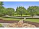 Stunning circular driveway with lush greenery and manicured landscaping creates a welcoming entrance at 400 Conservatory Pt, Fayetteville, GA 30215