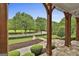 View of the lush front yard from the covered porch, showcasing mature trees and manicured landscaping at 400 Conservatory Pt, Fayetteville, GA 30215