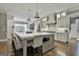 Bright, spacious kitchen features a large center island with seating, stainless steel appliances, and hardwood floors at 400 Conservatory Pt, Fayetteville, GA 30215