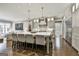 Modern kitchen with a large island, white cabinetry, and stainless steel appliances, ideal for cooking at 400 Conservatory Pt, Fayetteville, GA 30215