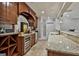 Kitchenette area featuring a wine cooler, custom cabinets, and stone countertops at 400 Conservatory Pt, Fayetteville, GA 30215