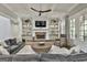 Cozy living room with a fireplace, built-in shelves, and comfortable seating, perfect for relaxing at 400 Conservatory Pt, Fayetteville, GA 30215