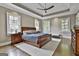 Spacious bedroom with a tray ceiling, hardwood floors, and ample natural light at 400 Conservatory Pt, Fayetteville, GA 30215