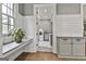 Mud room with shiplap walls with built-in storage; laundry room is through the doorway at 400 Conservatory Pt, Fayetteville, GA 30215