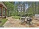 Inviting stone patio featuring an outdoor dining area and a grill, perfect for entertaining at 400 Conservatory Pt, Fayetteville, GA 30215