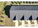 A very high angle aerial view of the townhouses with green lawns at 142 Hampton Cir, Mcdonough, GA 30253