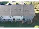 An aerial view of the townhouses shows patios, roof lines, and green lawns at 142 Hampton Cir, Mcdonough, GA 30253