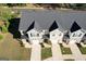 Aerial view of the townhouses with nice roof lines and green lawns at 142 Hampton Cir, Mcdonough, GA 30253