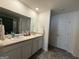 This bathroom features double sinks, a large mirror, and modern neutral finishes at 142 Hampton Cir, Mcdonough, GA 30253