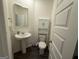 Bathroom featuring a pedestal sink and a toilet with storage at 142 Hampton Cir, Mcdonough, GA 30253
