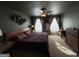 This bedroom offers a ceiling fan, natural light, and a view of a window at 142 Hampton Cir, Mcdonough, GA 30253