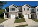Charming townhouse featuring a brick facade, attached garage, and well-manicured front lawn at 142 Hampton Cir, Mcdonough, GA 30253