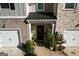 Close up view of the front door with plants, a welcome mat and the unit number at 142 Hampton Cir, Mcdonough, GA 30253