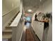 Hallway with hardwood floors, coat rack, area rug and stairwell at 142 Hampton Cir, Mcdonough, GA 30253